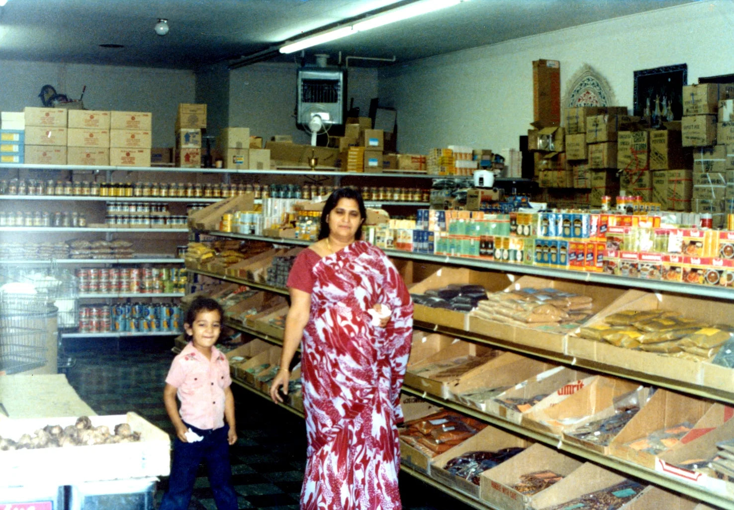 Suneel's mother and a young Suneel in the family's original Los Angeles shop, 1979
